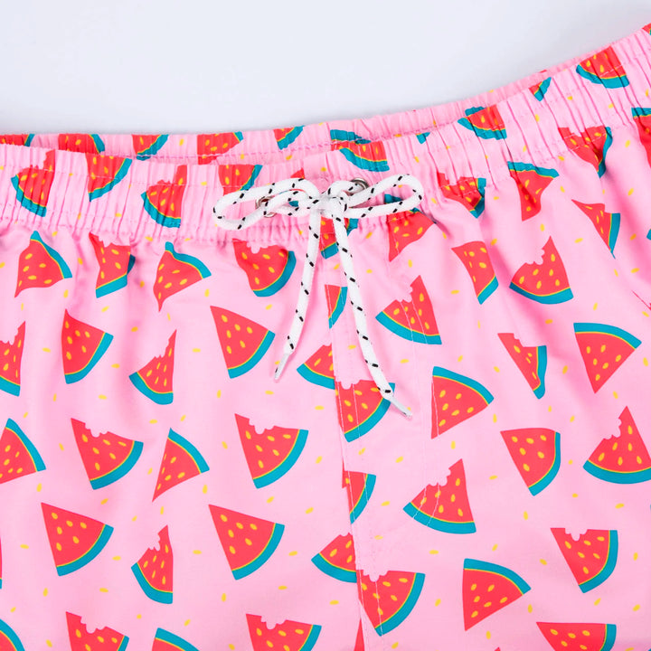 Model draagt stijlvolle heren zwemshort Milo met vrolijke zomerprint, comfortabel en modieus.
