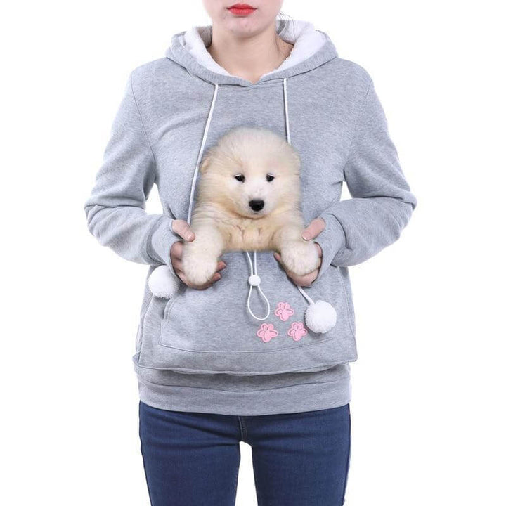 Dierenliefhebber draagt CozyPurr hoodie met tevreden kat in de draagzak. Zachte, comfortabele hoodie.
