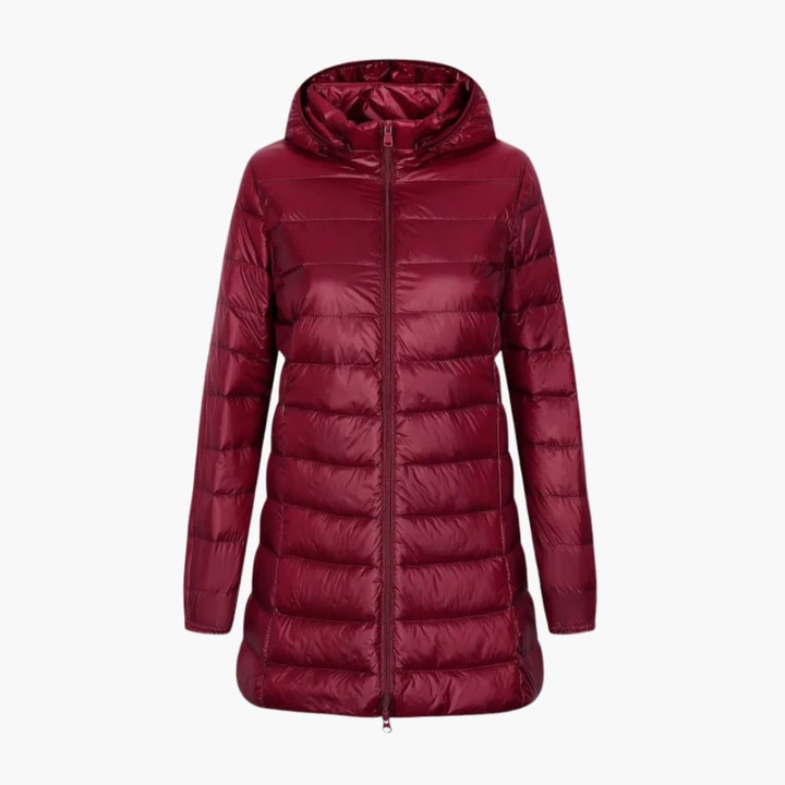 Stijlvol gewatteerd donsjack voor dames met capuchon en lange snit. Ideaal als warme wintermode buitenjas.