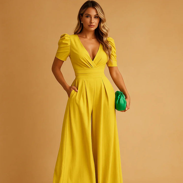 Stijlvolle gele jumpsuit voor dames met korte pofmouwen en getailleerde taille