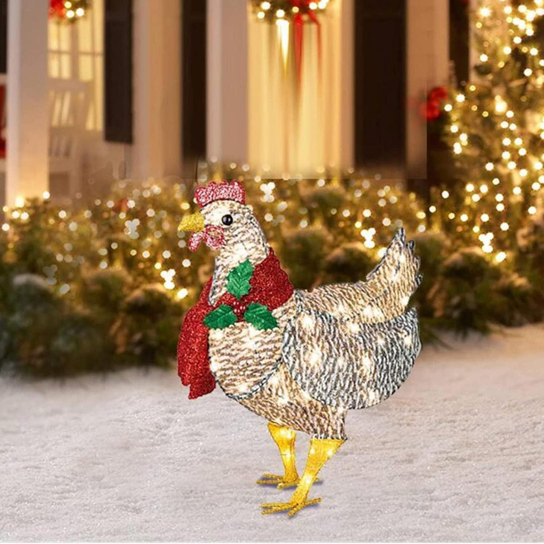 Vrolijke lichtgevende kip met sjaal als tuindecoratie. LED kerstverlichting voor een feestelijke buitenruimte.