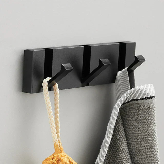 Zwarte wandhaak, inklapbaar en stijlvol, voor een minimalistisch interieur met maximale ruimte.