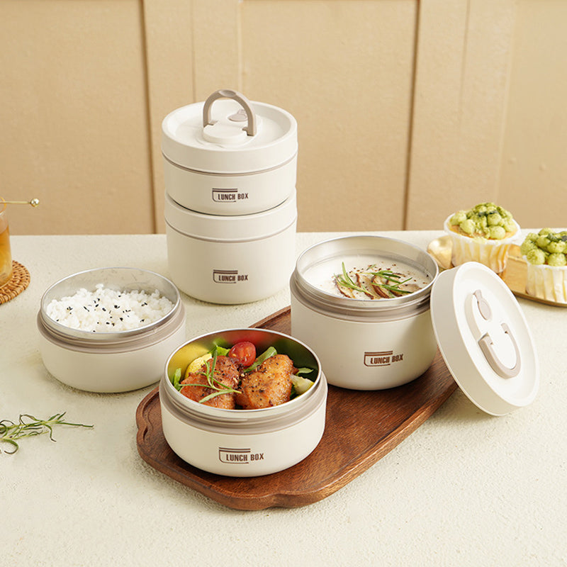 Meerlagige geïsoleerde RVS lunchbox set met draagtas, ideaal voor school of kantoor.