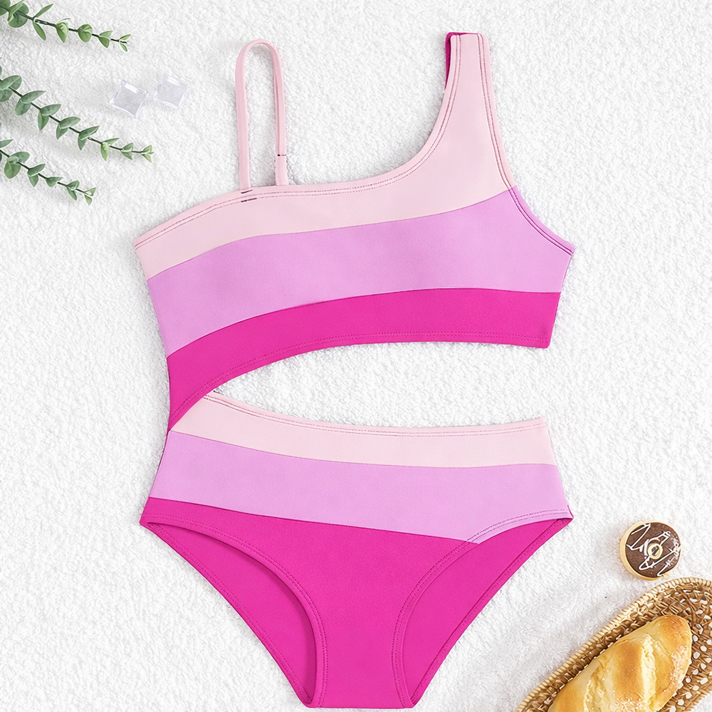 Trendy meisjes badpak met taille uitholling en kleurblok, ideaal voor strand, zwembad of vakantie.