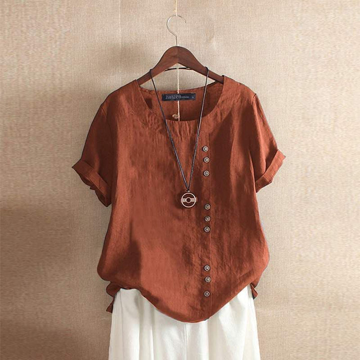 Stijlvolle zomerblouse voor dames met asymmetrische knoopdetails, korte mouwen en een trendy ronde hals. Modern en kleurrijk.