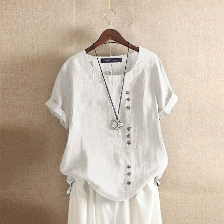 Damesblouse met korte mouwen, unieke asymmetrische knoopsluiting en comfortabele ronde hals. Een modieuze en veelzijdige top.