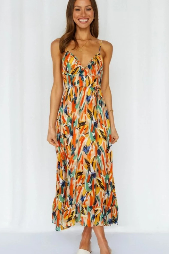 Isla printjurk voor dames, mouwloos met vrolijke oranje en turkoois kleuren, perfect voor warme zomerdagen.