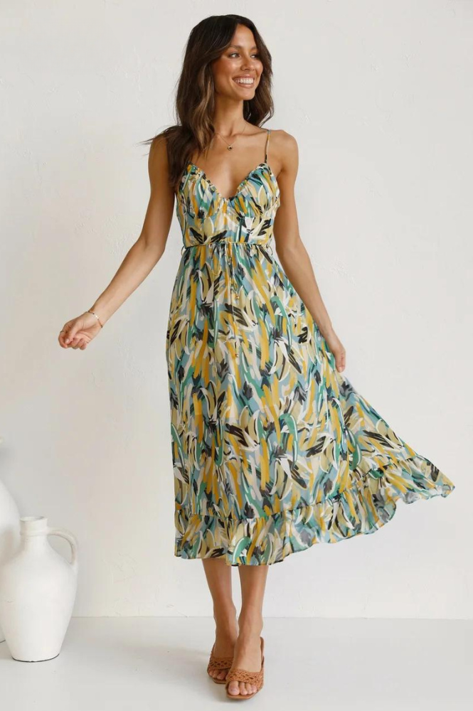 Comfortabele dames mouwloze zomerjurk in oranje-turkoois print. Stijlvol voor casual en vakantie.