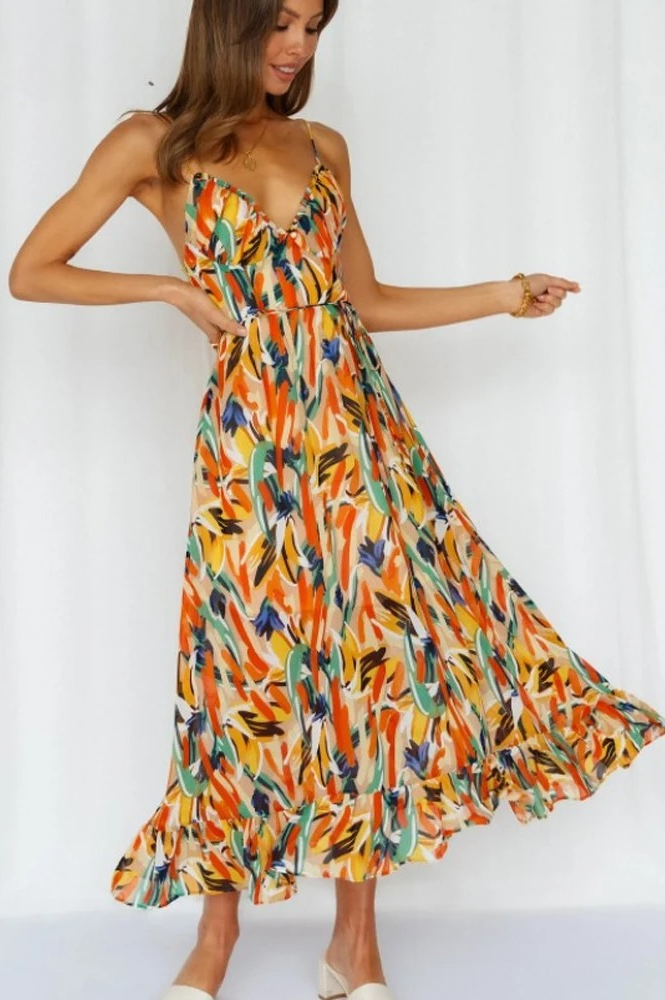 Vrolijke, comfortabele mouwloze zomerjurk voor dames met levendige oranje-turkoois print. Perfect voor casual.