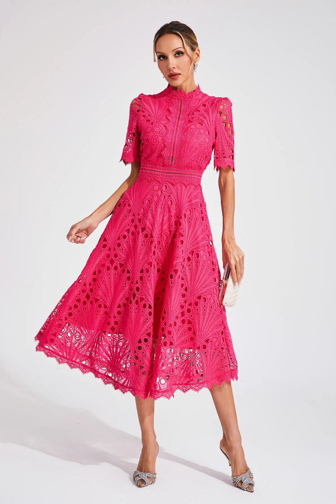 Model draagt roze A-lijn midi jurk met V-hals, elegant en stijlvol voor elke gelegenheid.