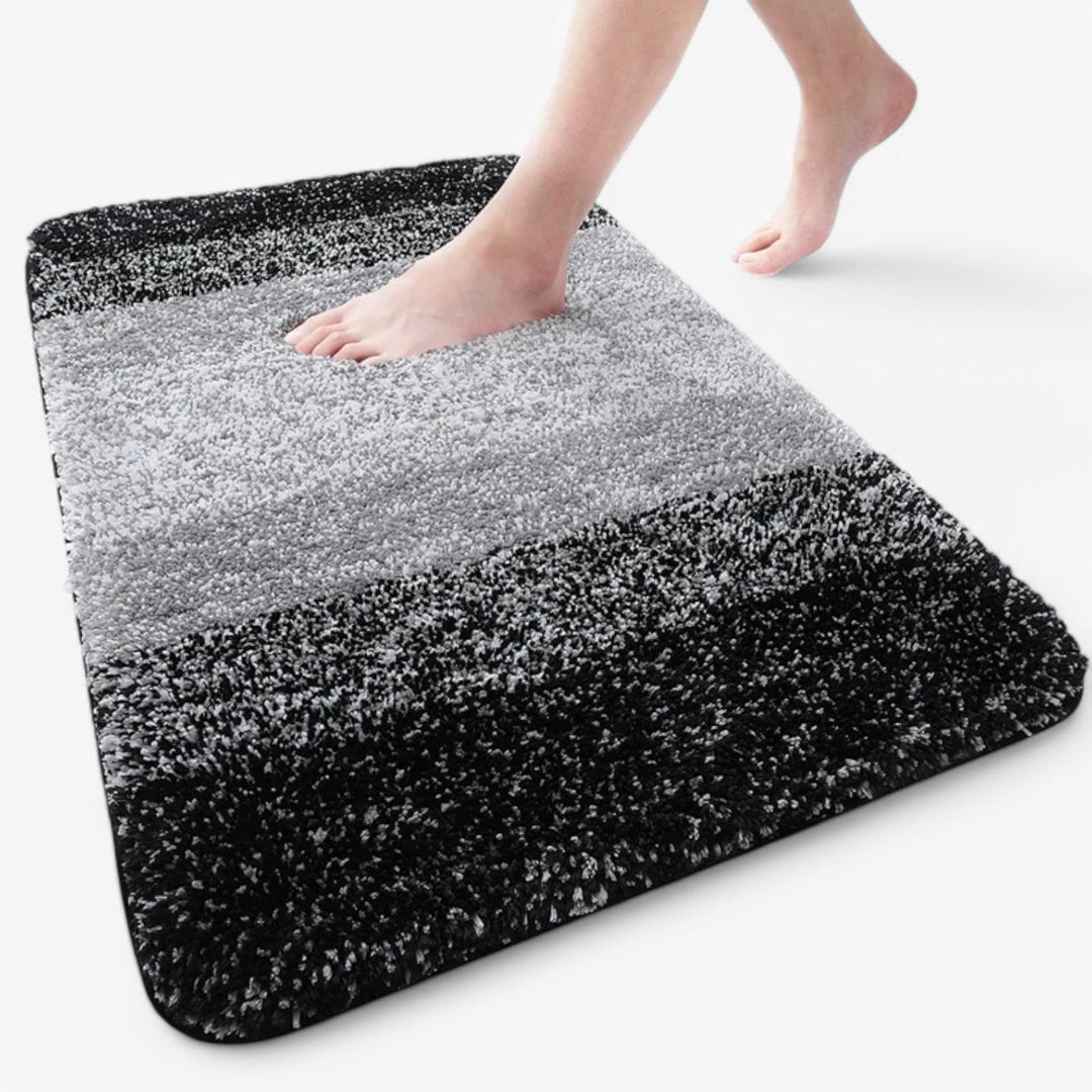 Deze sneldrogende microvezel badmat absorbeert water direct, houdt uw badkamer droog en hygiënisch.