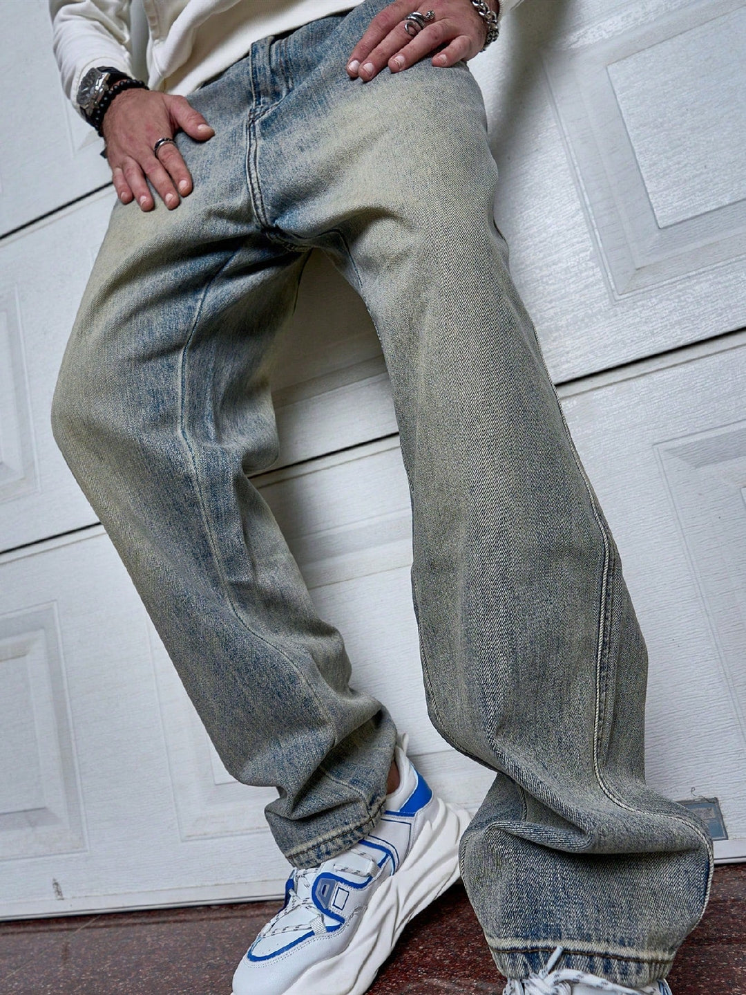 Man draagt tijdloze donkerblauwe straight-fit heren jeans, casual en comfortabel voor elke gelegenheid.