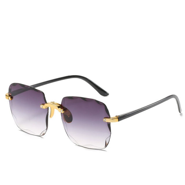 Trendy randloze zonnebril Clea in vintage stijl, biedt optimale UV400 oogbescherming. Perfect voor de zomer.