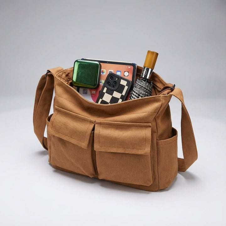 Georganiseerde en comfortabele canvas schoudertas, perfect voor reizen en werk.