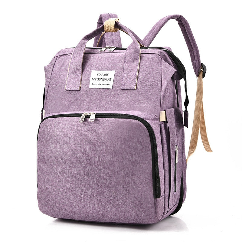 Stijlvolle unisex babytas met meerdere vakken, inclusief opvouwbaar babybed voor onderweg.