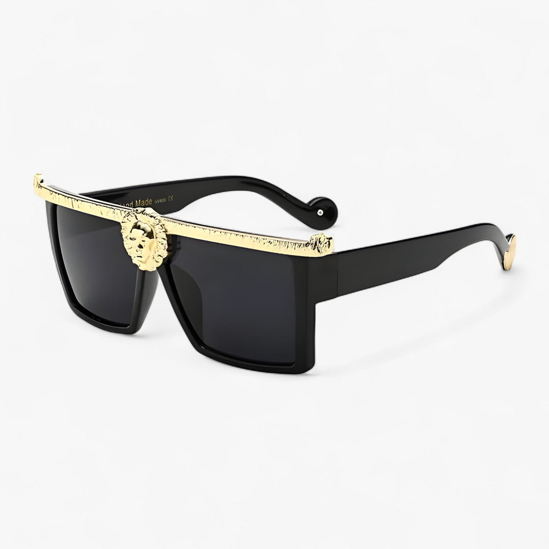 Goud-zwarte retro zonnebril met leeuwenstijl, trendy en krachtig voor elke outfit.