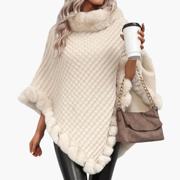 Comfortabele eenheidsmaat gebreide poncho voor vrouwen, afgewerkt met zachte nepbont. Ideale wintermode.