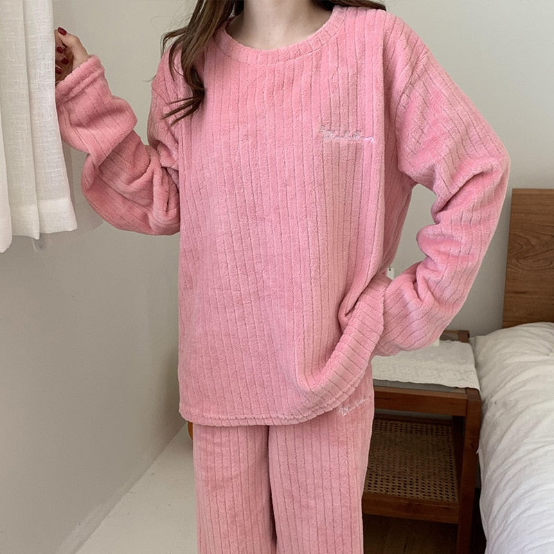 Detail van zachte koraalfleece stof van deze warme damespyjama set. Comfortabele winter loungewear.