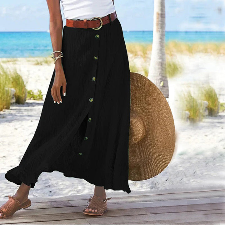 "Zomerse maxi-rok in groen; A-lijn silhouet met knoopdetails, ideale dameskleding voor warme dagen."