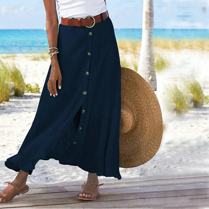 "Zomerse maxi-rok in groen; A-lijn silhouet met knoopdetails, ideale dameskleding voor warme dagen."