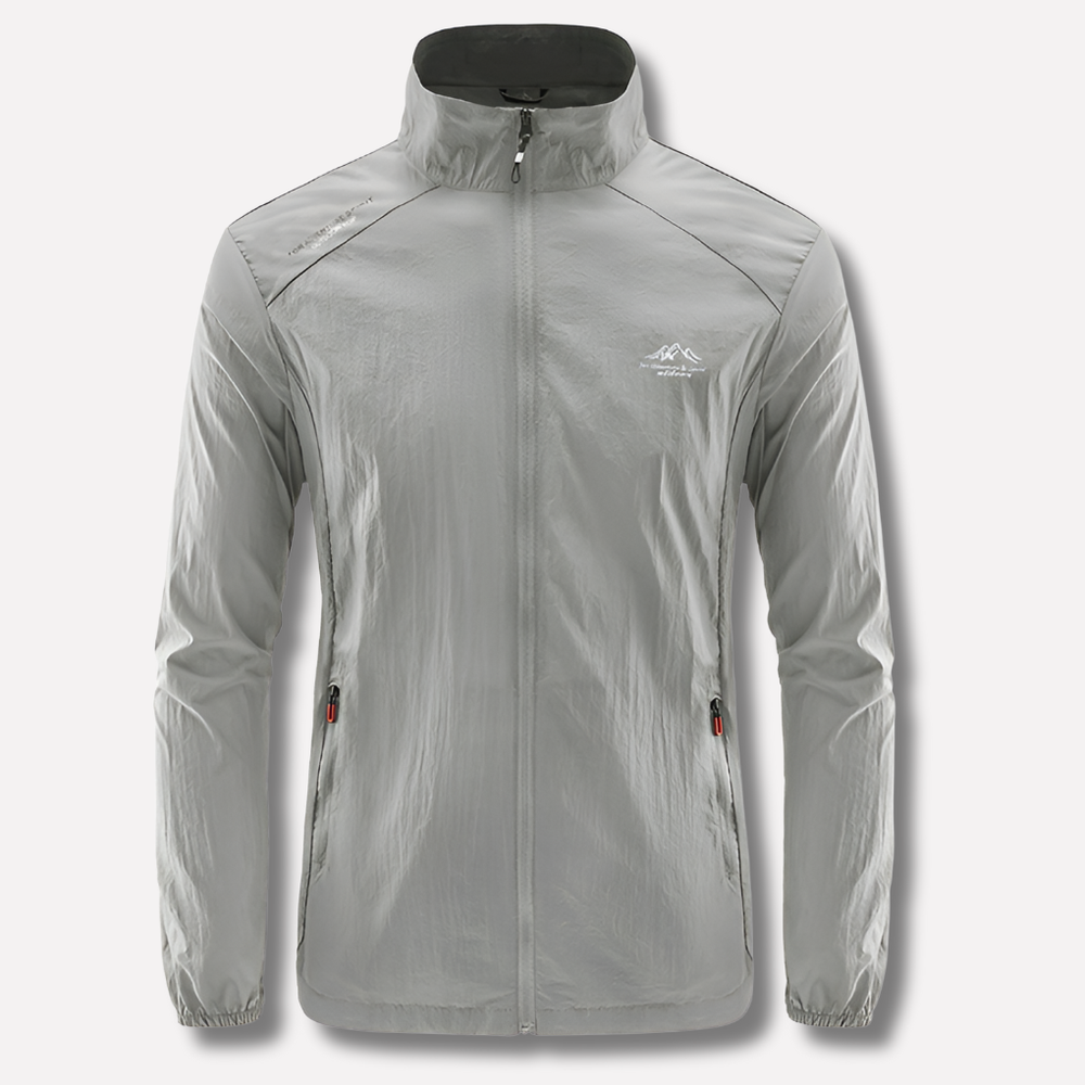 Model draagt comfortabel lichtgewicht heren windjack. Winddichte zomerjas perfect voor sportieve buitenactiviteiten.