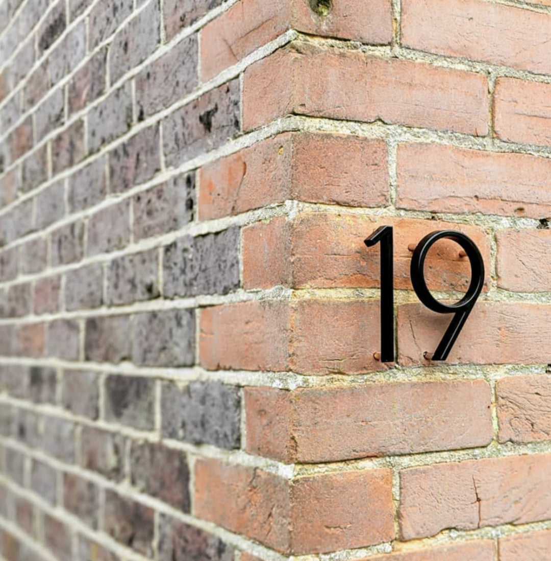 Zwart modern huisnummer "Numbré" met zwevend design voor gevel. Stijlvolle exterieurdecoratie.